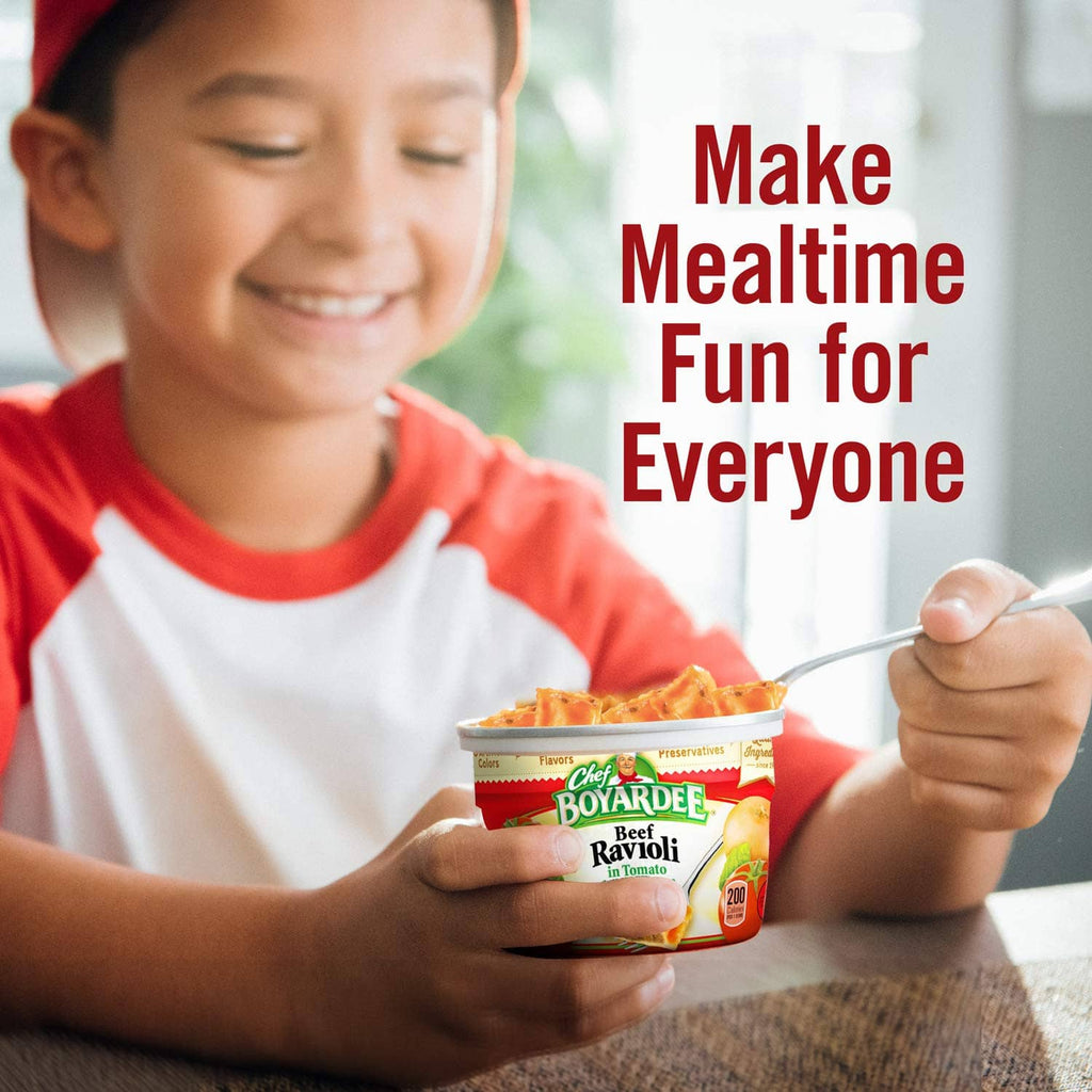 Child holding a Chef Boyardee beef ravioli cup for a quick meal