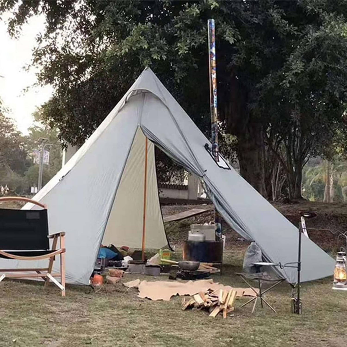 Tent with roof stove jack and chimney opening above a camping cooking area