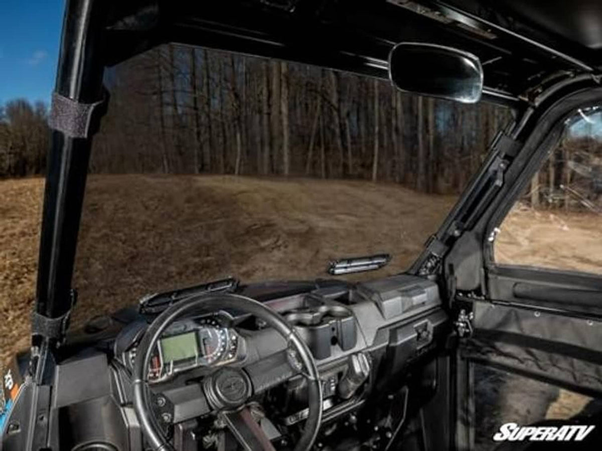 Interior view through dark-tinted windshield with dashboard visible from driver seat