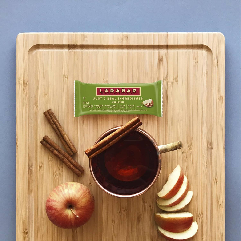 Apple pie bar wrapper with apple slices, cinnamon sticks, and small bowl
