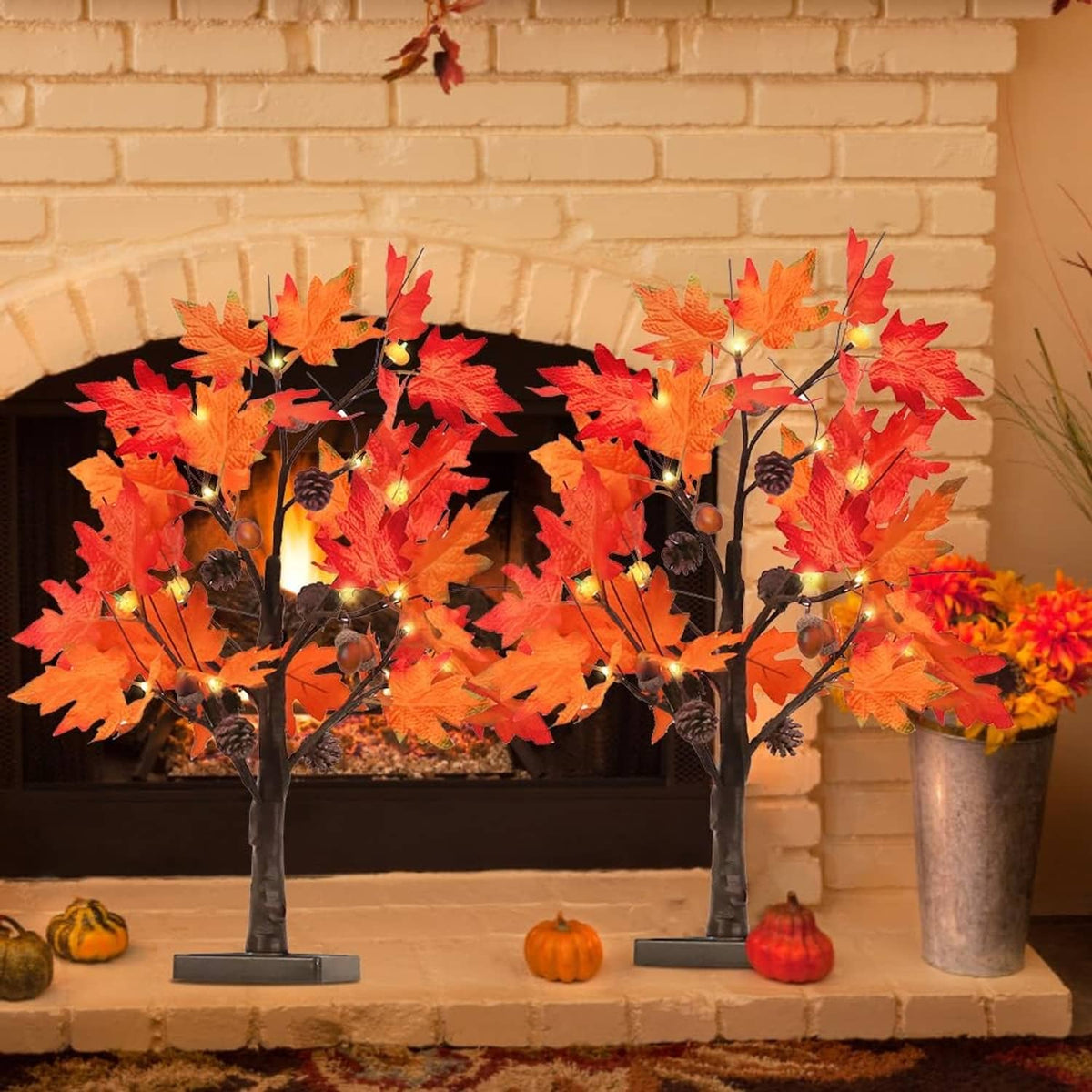 Warm-lit fall maple leaf tree decorations with two black twig trunks