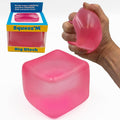 Pink squishy block cube stress toy held in hand