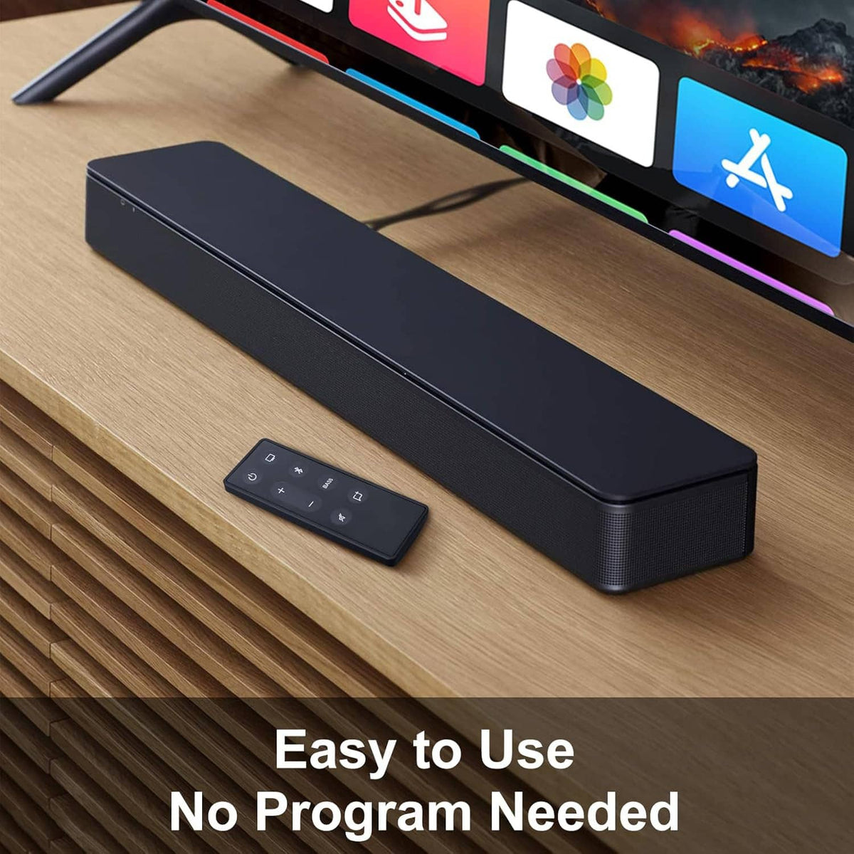Black remote control lying on a wooden surface