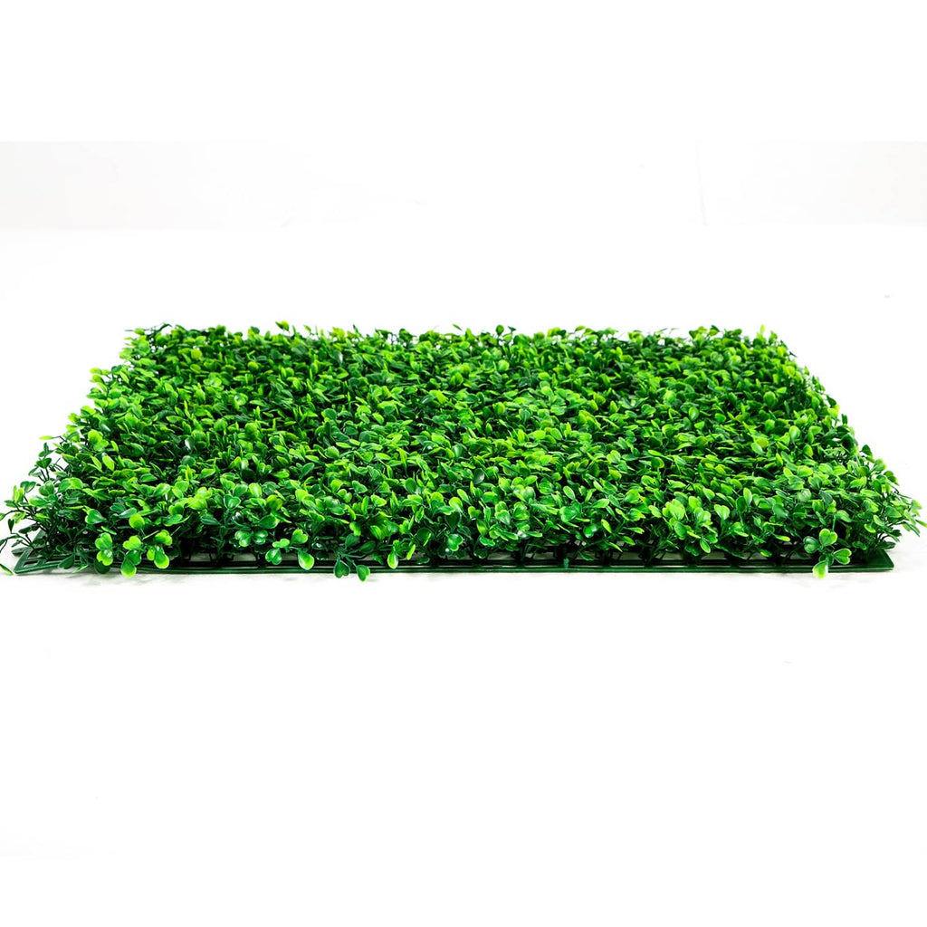 Artificial boxwood hedge panel laid flat, dense bright-green foliage mat