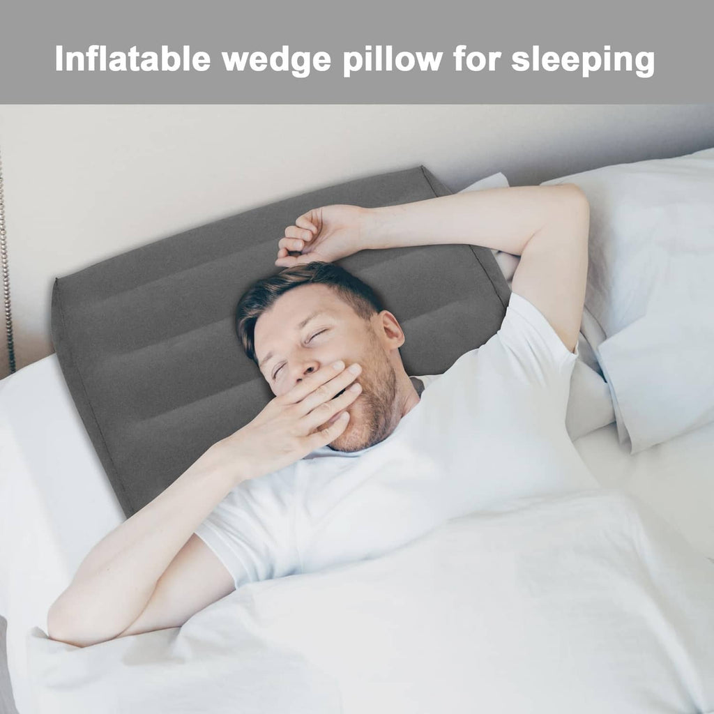Gray inflatable wedge pillow under head on a bed for elevated back rest