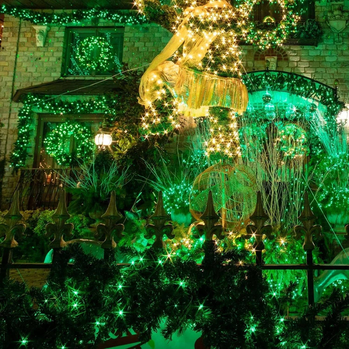 Green LED solar fairy lights covering outdoor railings and plants