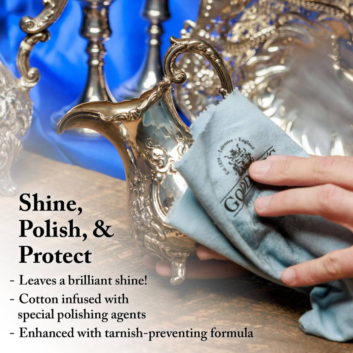 Silver polishing cloth wiping ornate metal jewelry pieces