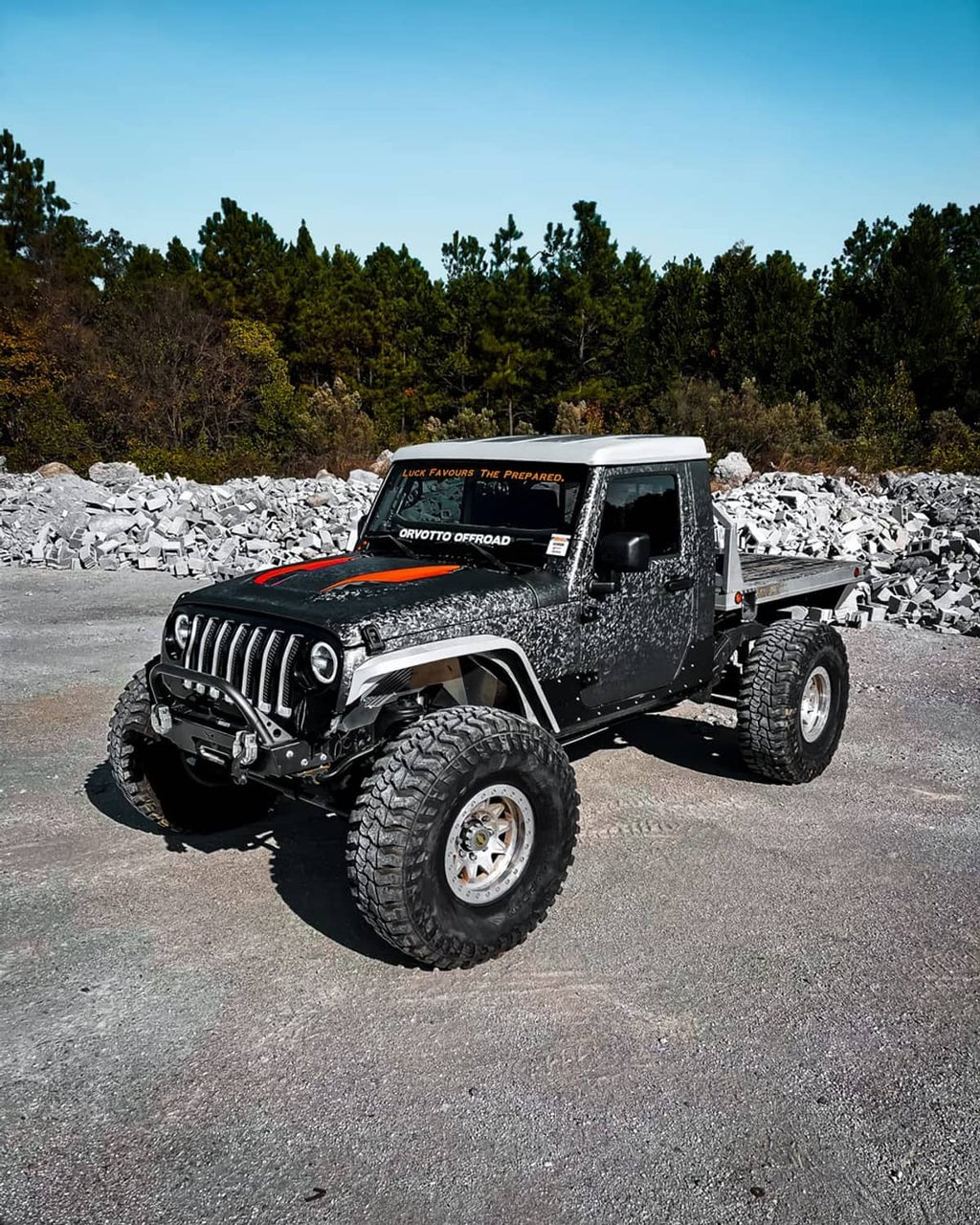 Gray metallic camo car vinyl wrap on off-road truck hood and fenders