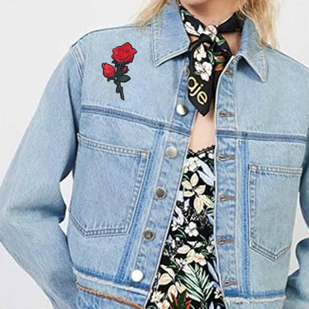 Light blue denim jacket with small embroidered red rose patch near the chest