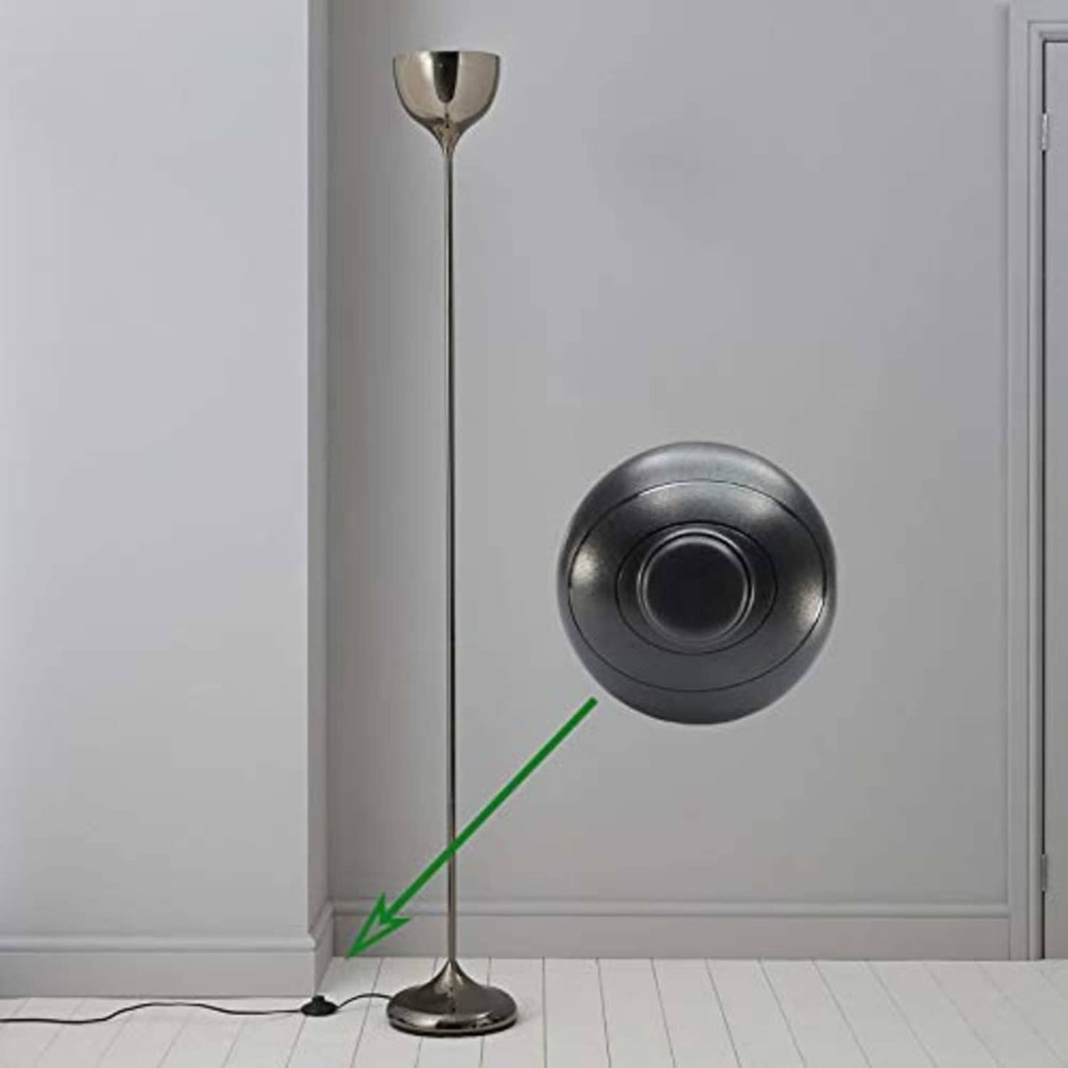 Black round foot pedal switch attached to a lamp cord near the floor, with circular button.