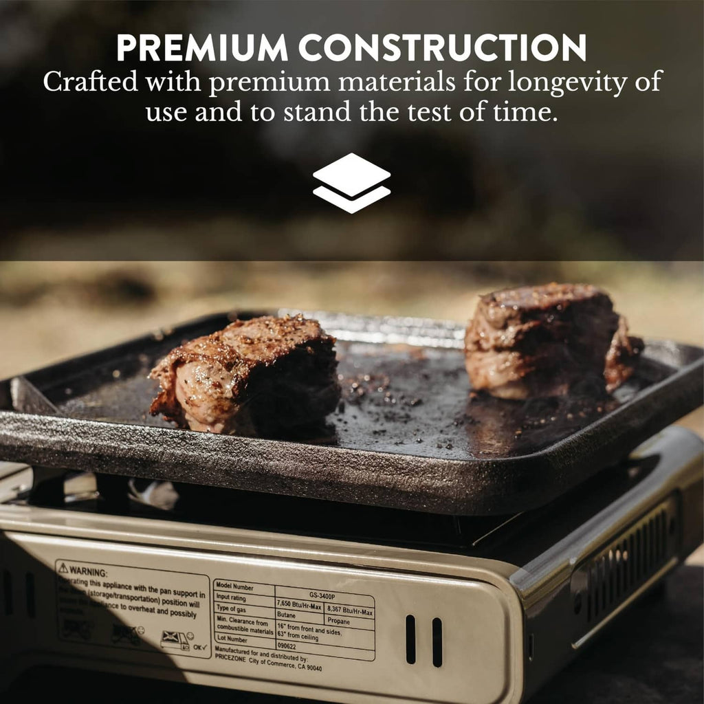 Portable camp stove with griddle on top, cooking surface over lit burner, beige housing