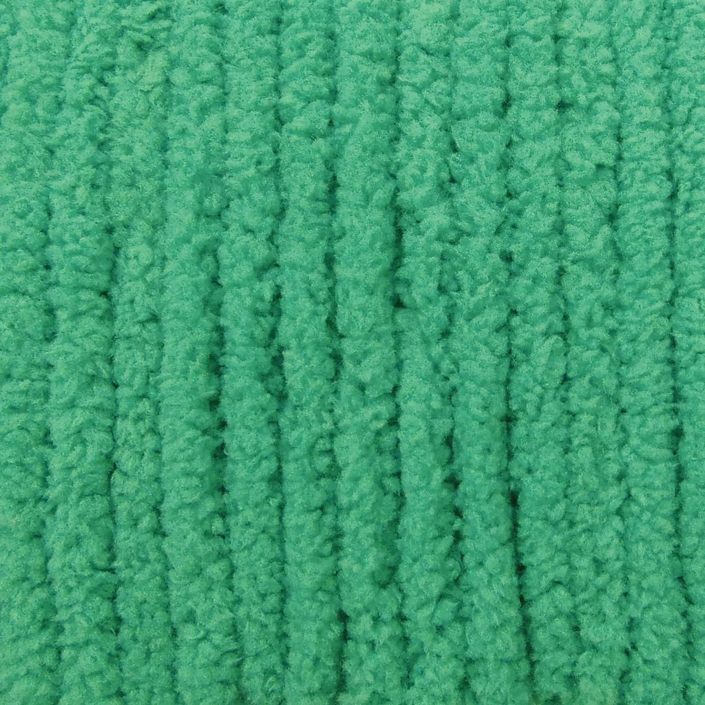 Close-up of bright green chenille knit yarn texture