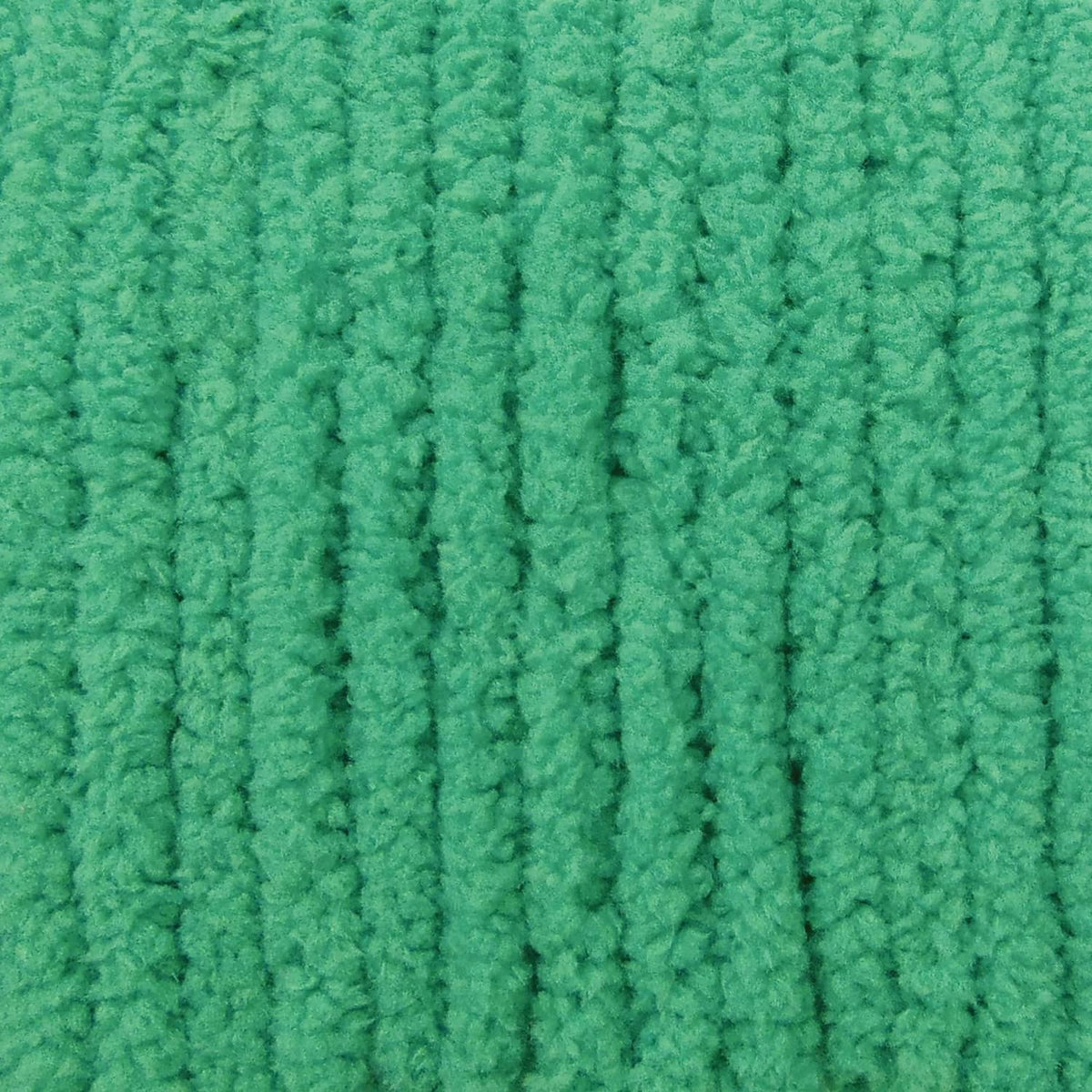Close-up of bright green chenille knit yarn texture
