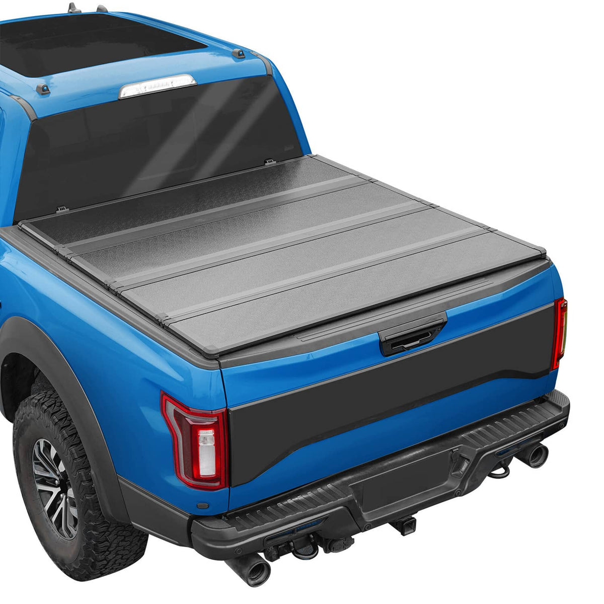Hard tri-fold tonneau cover installed on pickup bed, gray top panels with black edges