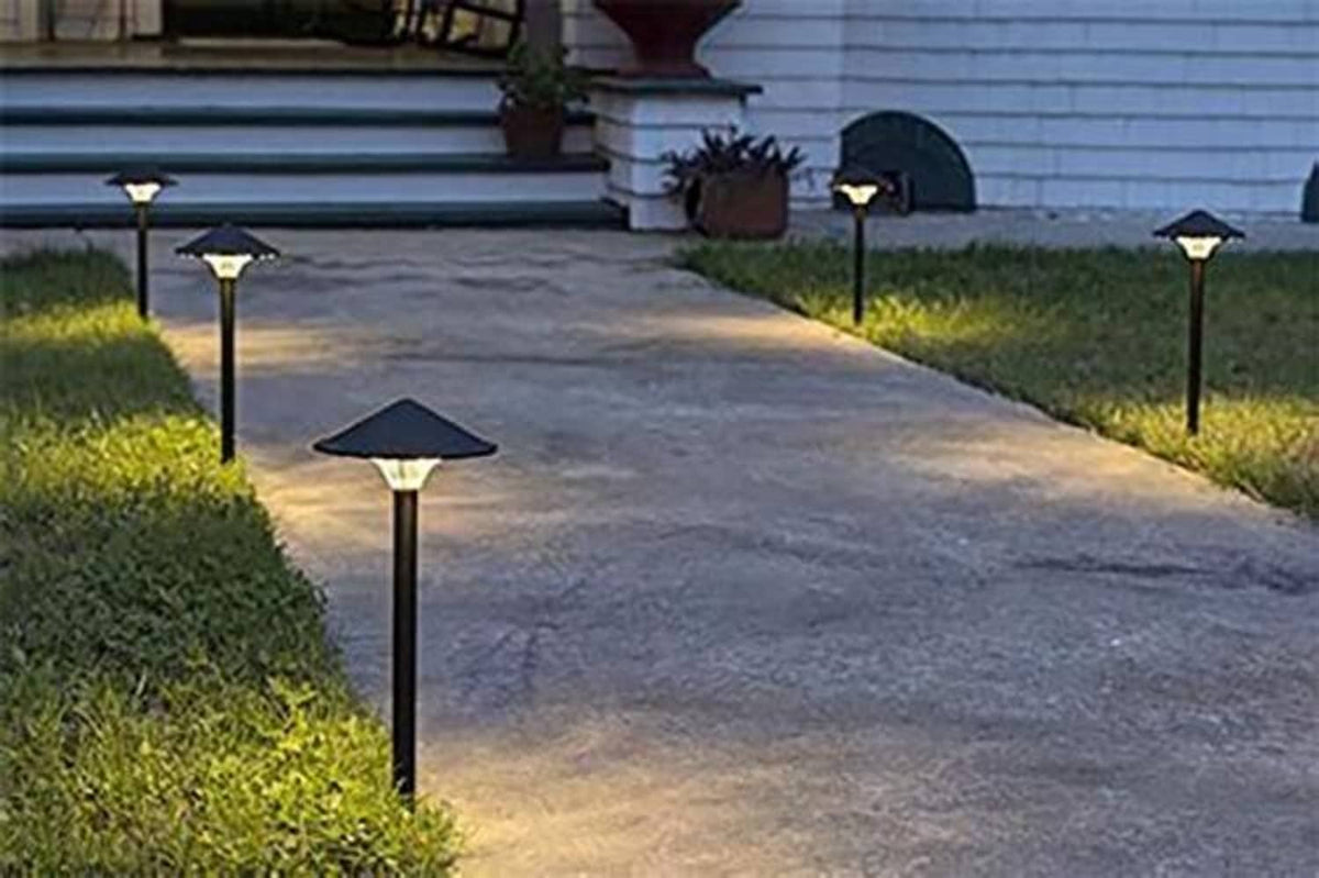 Outdoor garden path lights with small square heads and bright cool-white glow.
