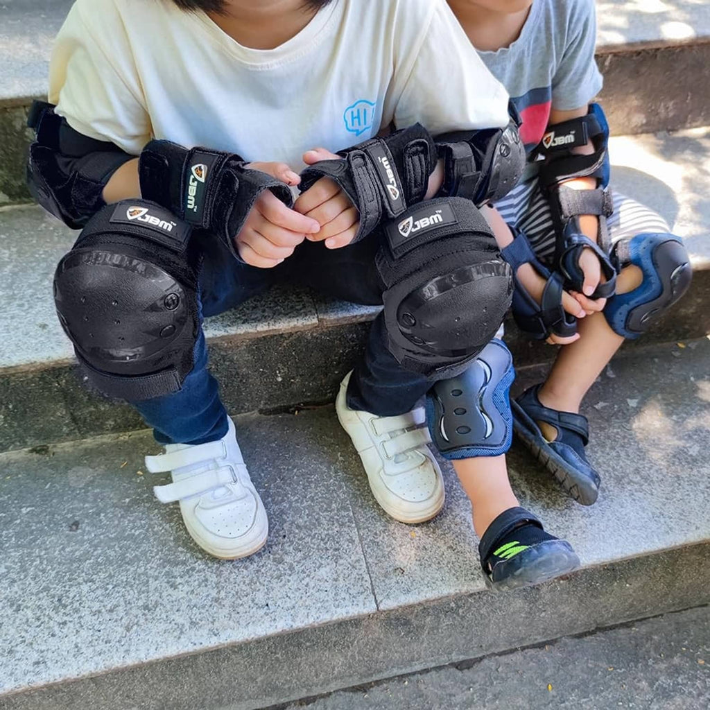 Kids wearing black knee, elbow, and wrist guards with hard shells