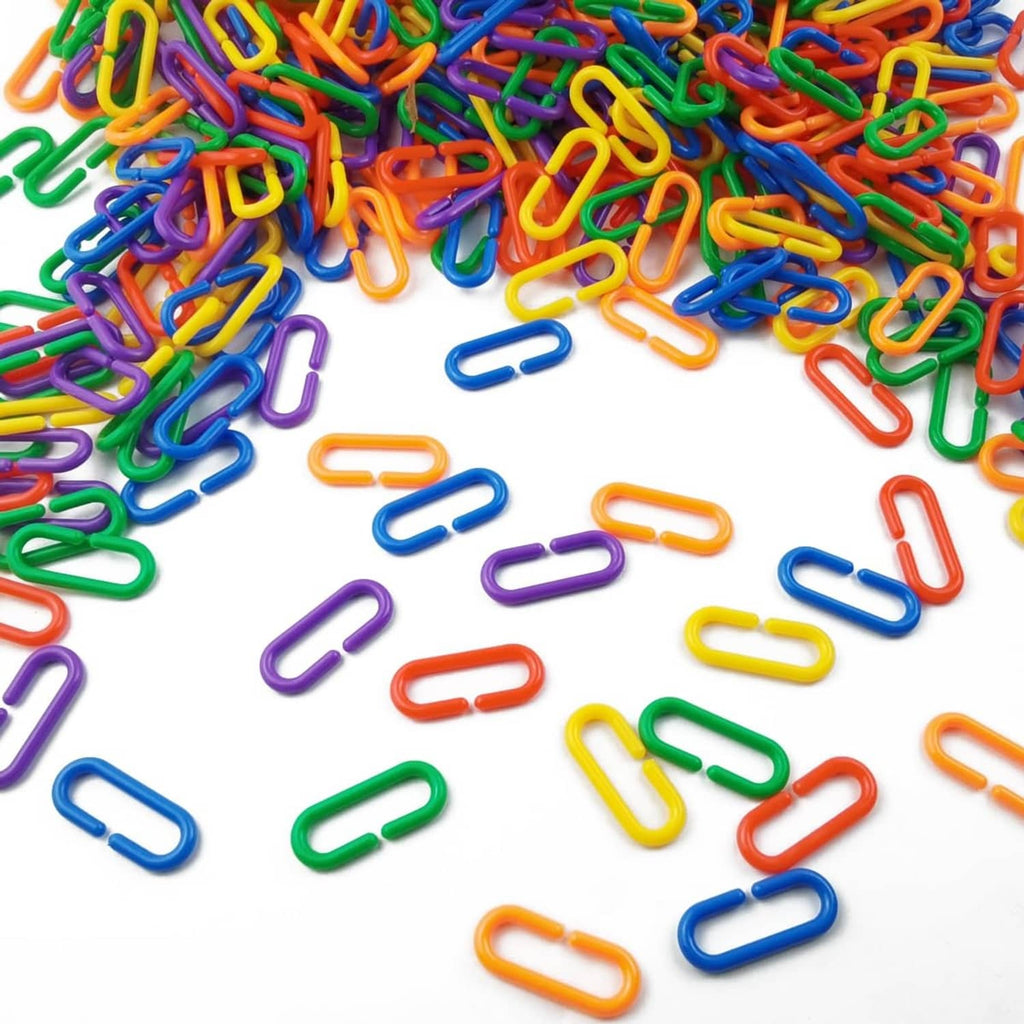Assorted multicolored plastic C-clips, scattered U-shaped loops
