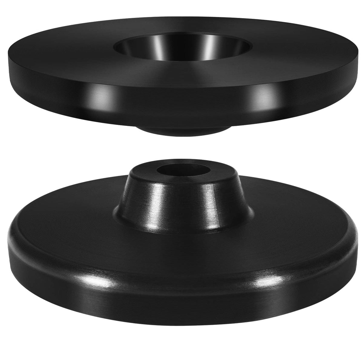 Black coil spring spacer discs, close-up pair with center mounting holes