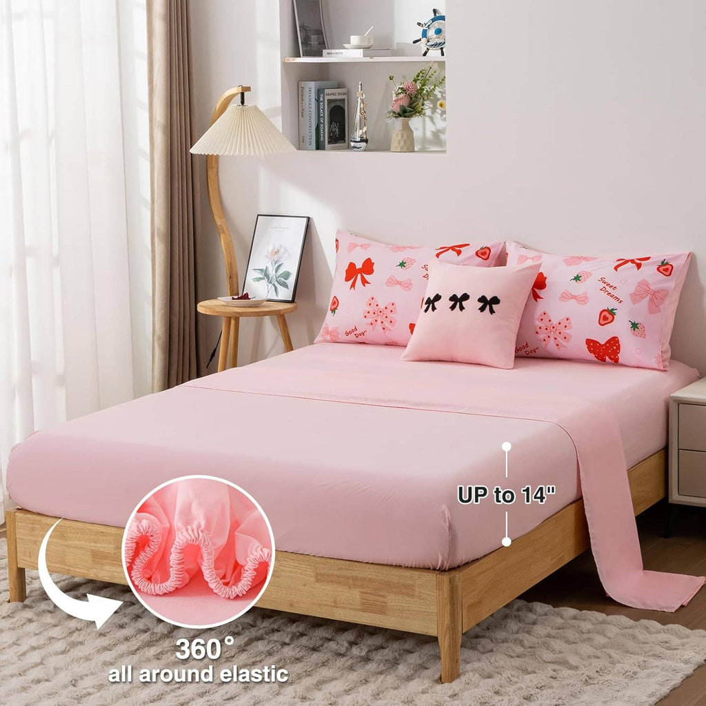 Pink comforter and pillow set with all-over bow and strawberry prints