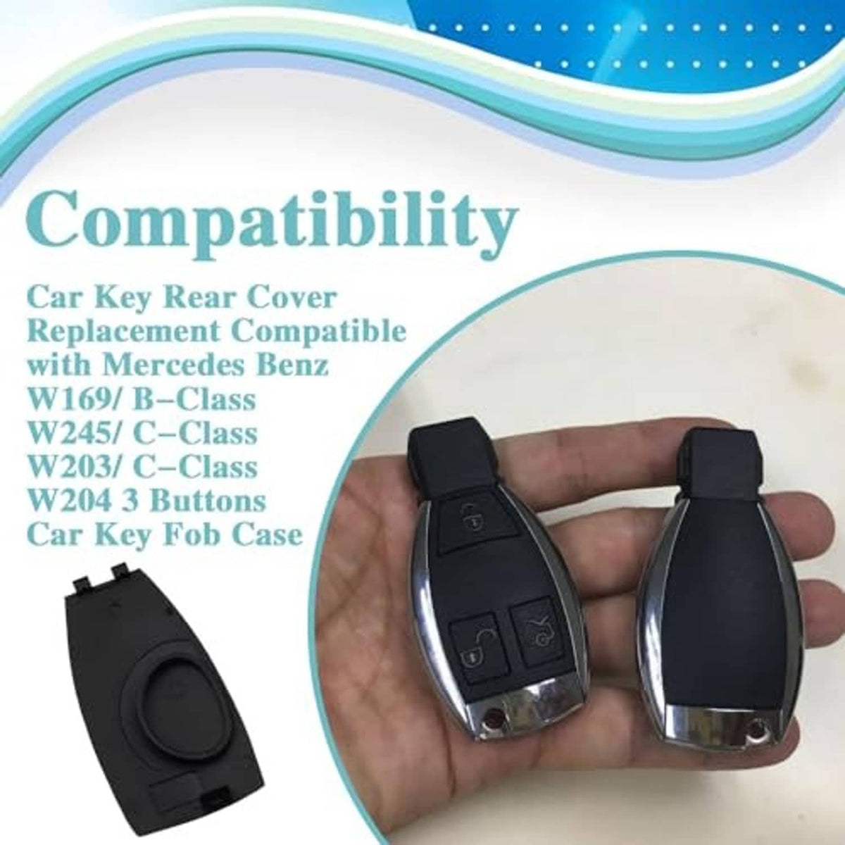 Black key fob rear cover shell held in hand, with metal keyring loop.