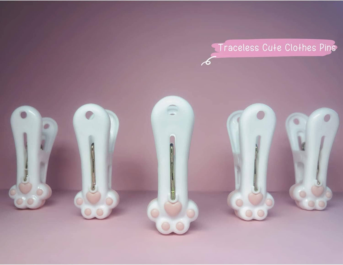 Cluster of white paw-decor plastic clothespins with metal springs