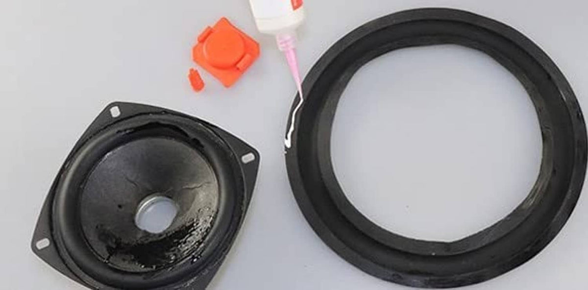 Black speaker surround ring replacement next to speaker driver opening.