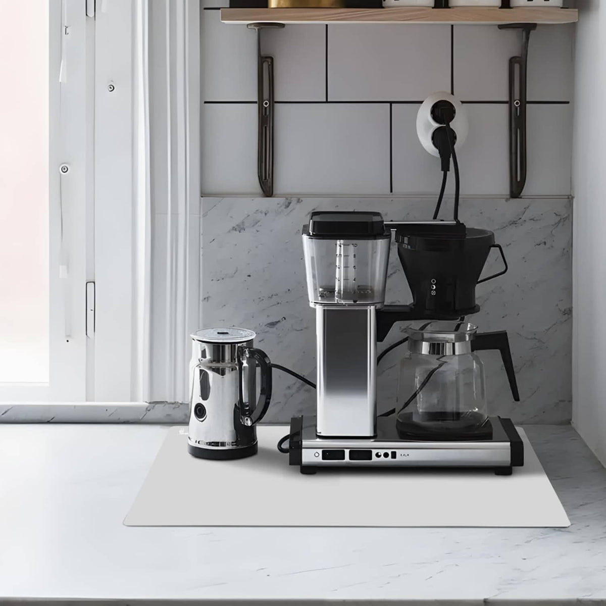 Gray silicone mat placed under kitchen appliances on a countertop
