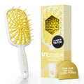 UNbrush detangling hair brush with white handle and yellow flexible bristles