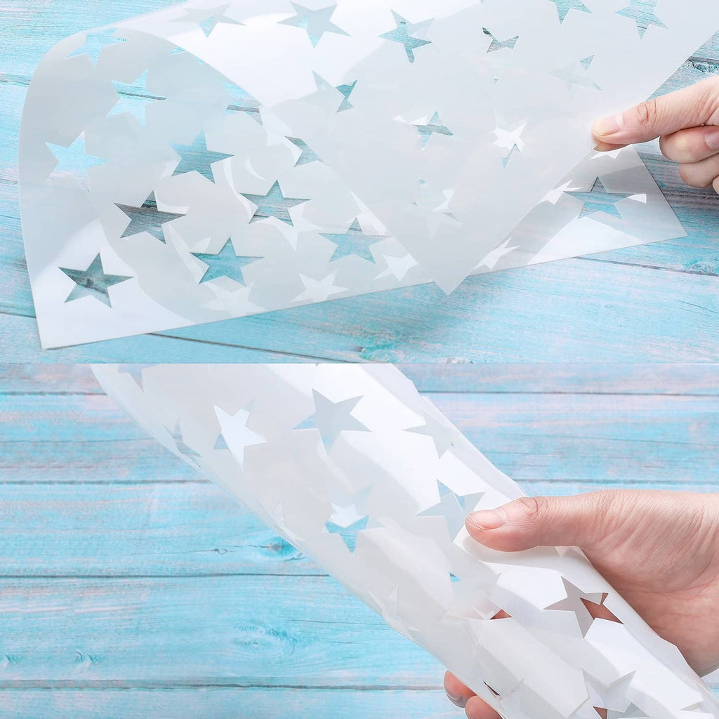 Transparent stencil sheet with light blue star cutouts, held for tracing
