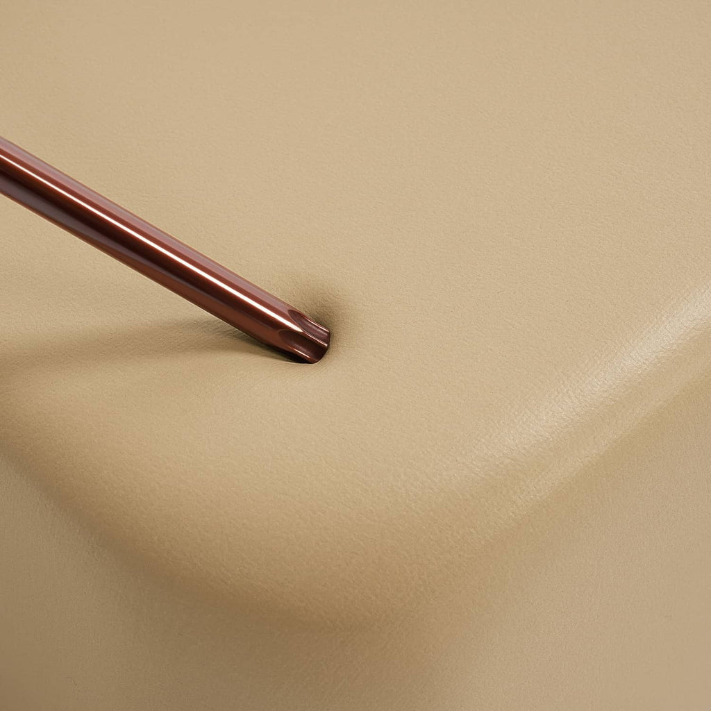 Tan seat cushion vinyl with visible seam and smooth, even texture