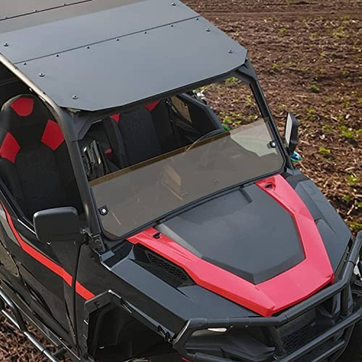 Dark tinted half windshield installed on Polaris side-by-side, front view angle