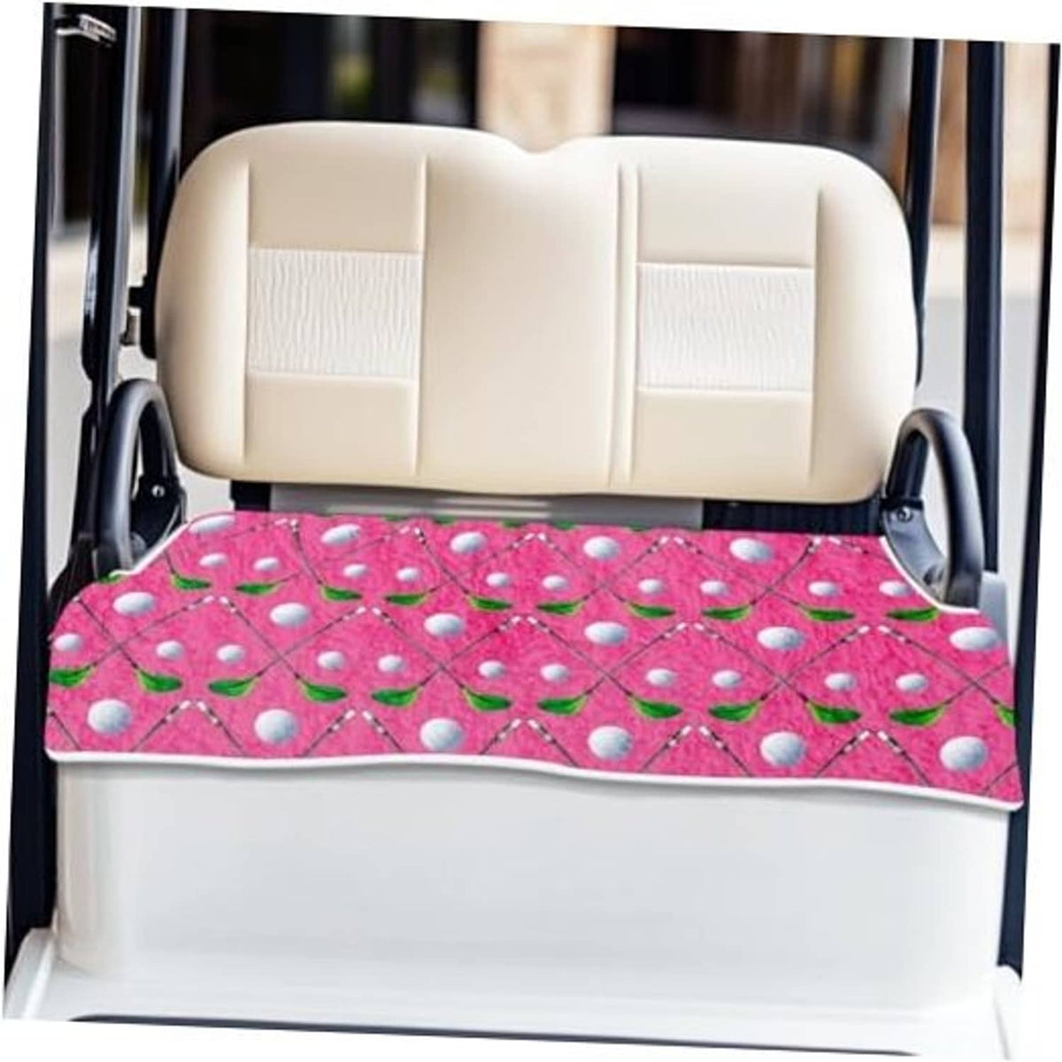 Golf cart seat cover in pink with leaf-and-dot pattern, fitted on beige seat back