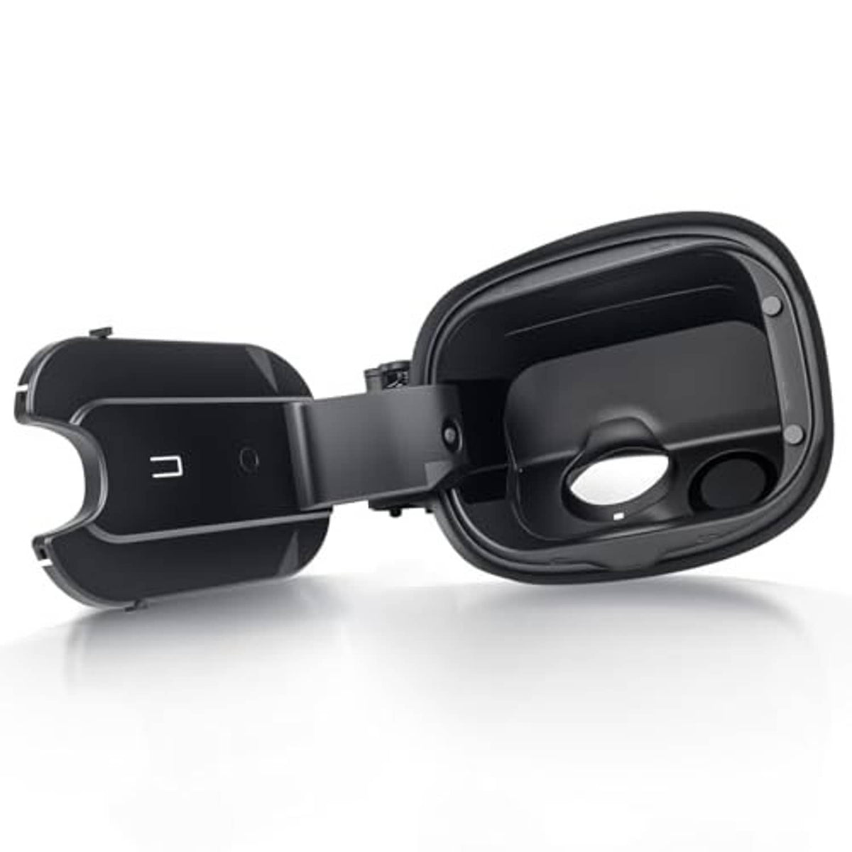 Black fuel tank filler door housing with left-side cap and circular opening