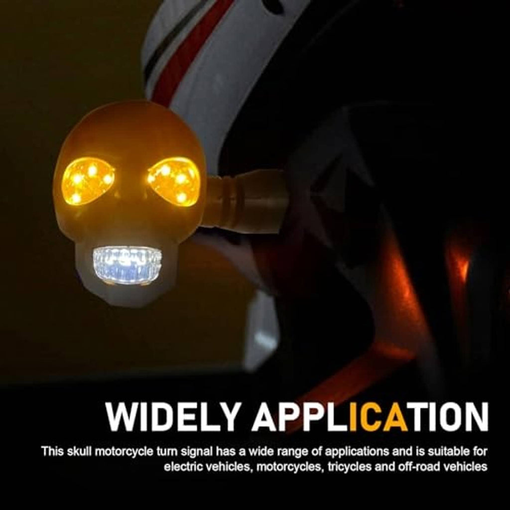 Illuminated skull motorcycle turn signal light with amber LEDs and clear lower lens on a bike