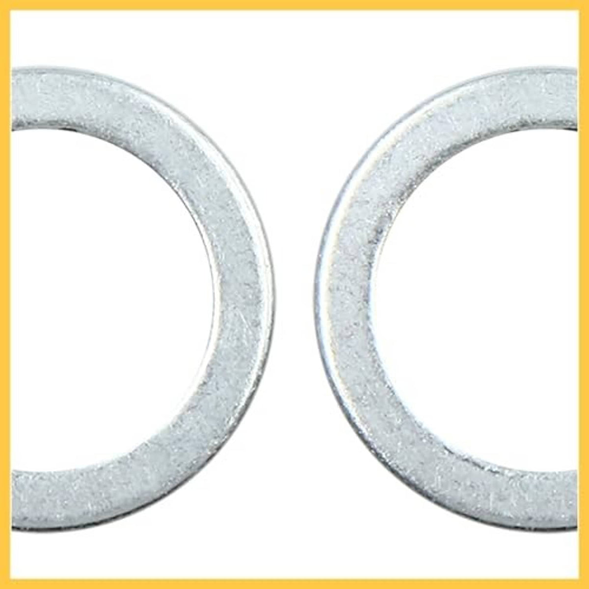 Close-up silver-gray crush washer faces, flat circular rings with inner holes