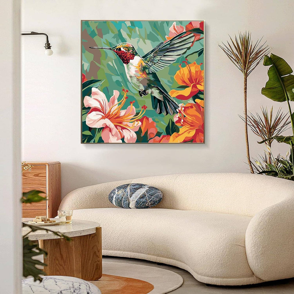 Paint-by-numbers hummingbird artwork in a wall frame above a sofa