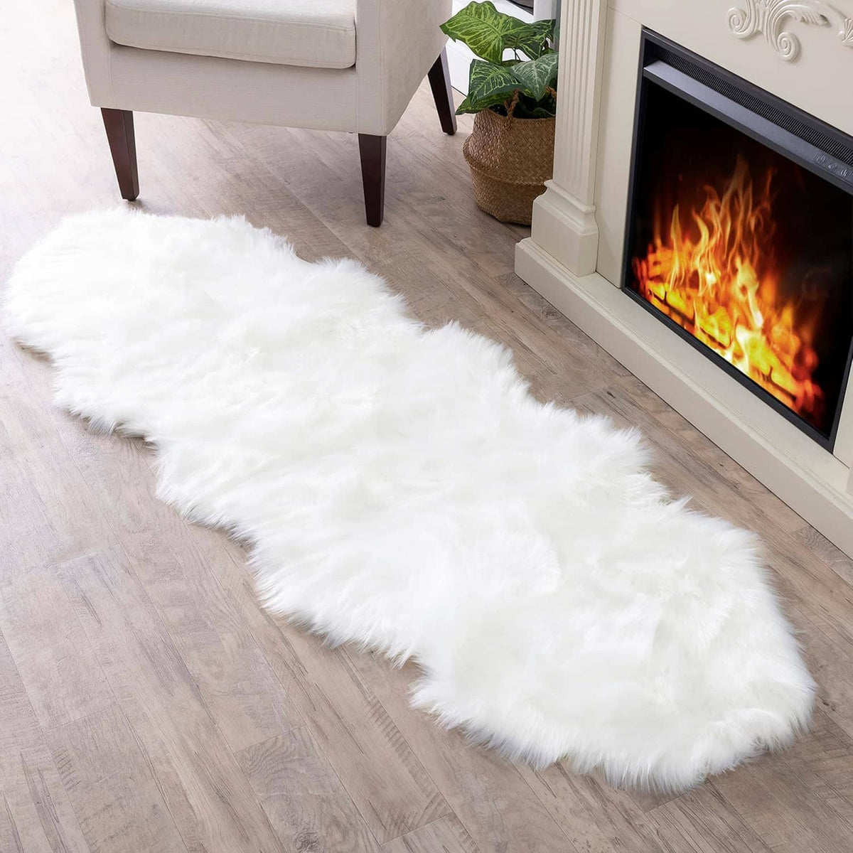 White faux fur sheepskin rug with long fluffy pile, oblong shape