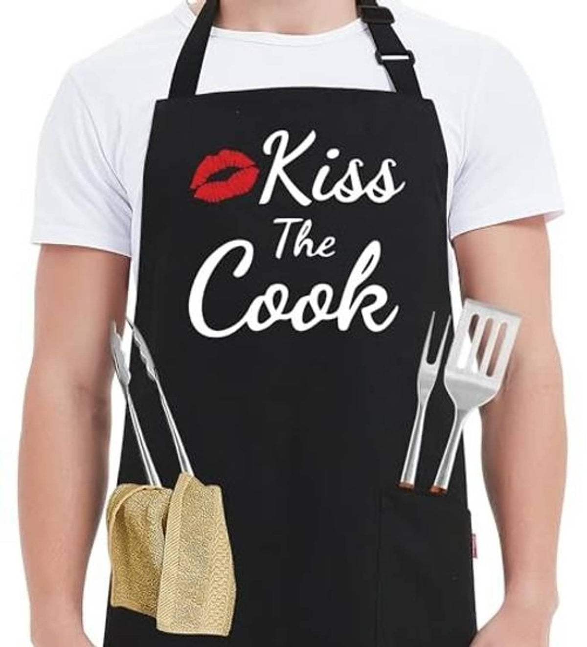 Black apron with “Kiss the Cook” lips graphic, fork and knife prints, and side pocket