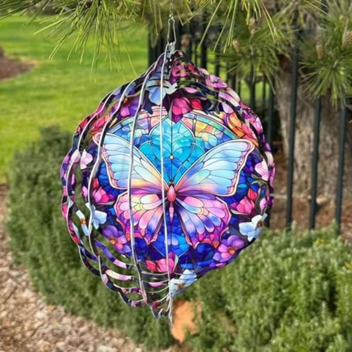 Circular butterfly stained-glass wind spinner hanging from a chain with metal hook
