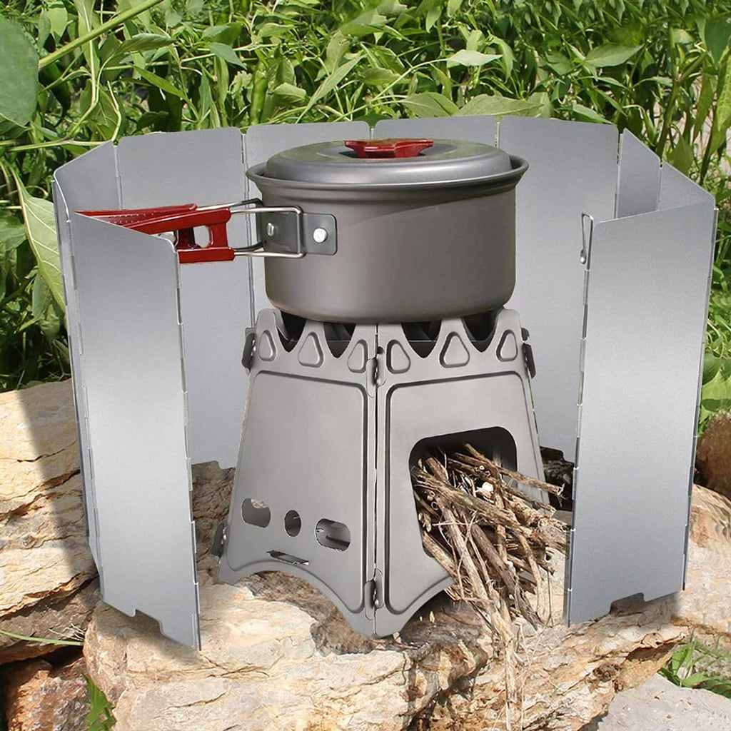 Gray aluminum stove windscreen panels surrounding a compact camping stove