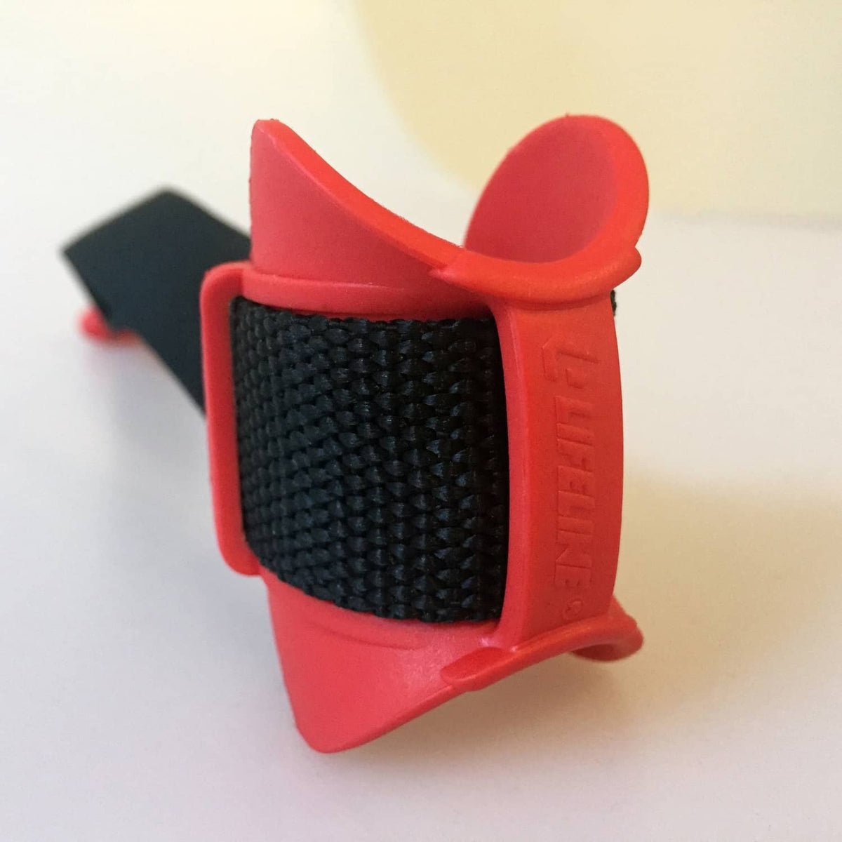 Door anchor latch with textured black strap and red mounting pads