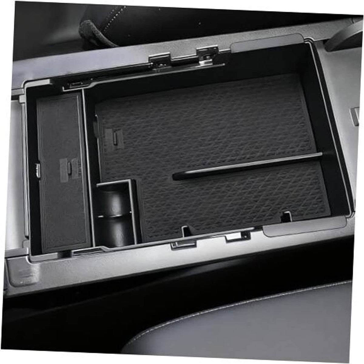 Dark textured armrest cover insert with storage compartments and side slot