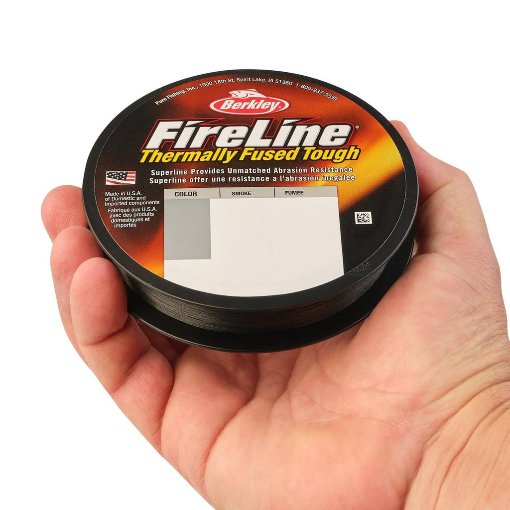 Braided fishing line spool with dark smoke line held in hand