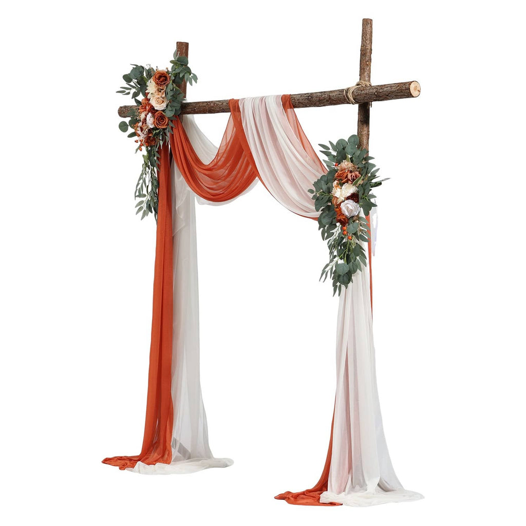 Artificial wedding arch kit with wooden cross, orange and white drapes, and floral greenery