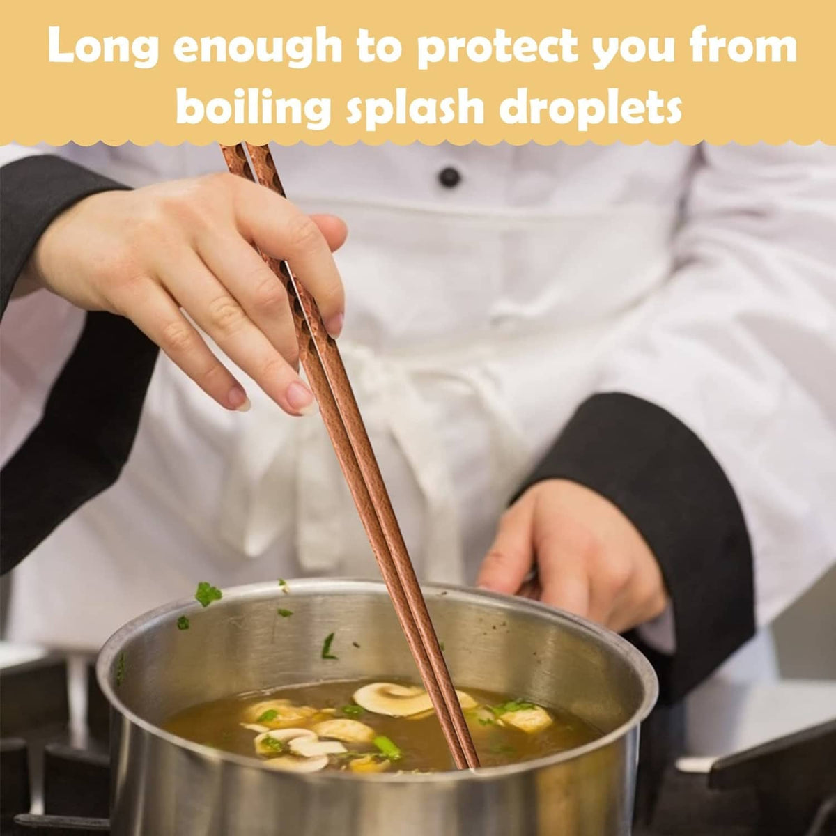 Beech wood chopsticks stirring a pot, held by a person in a kitchen setting