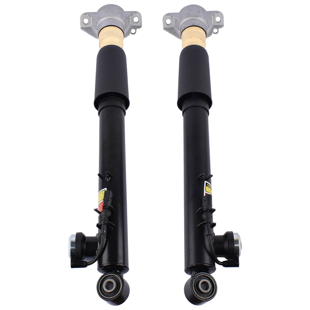 Pair of electronic shock struts with gray upper mounts and black cylinders, side linkage visible.