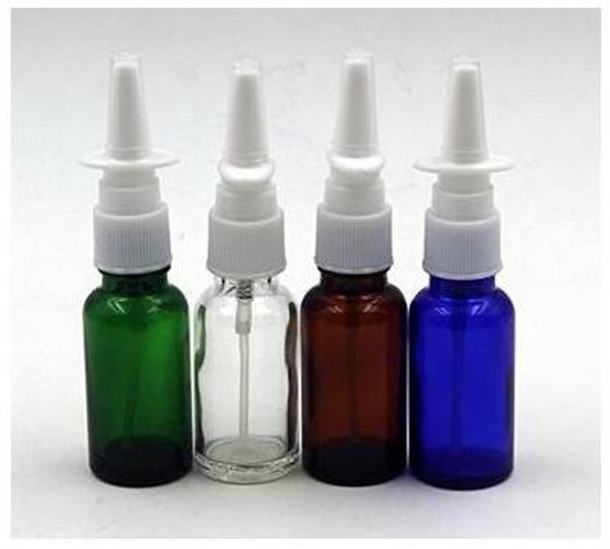 Refillable nasal bottles in green, clear, amber, and blue glass with white pump tops