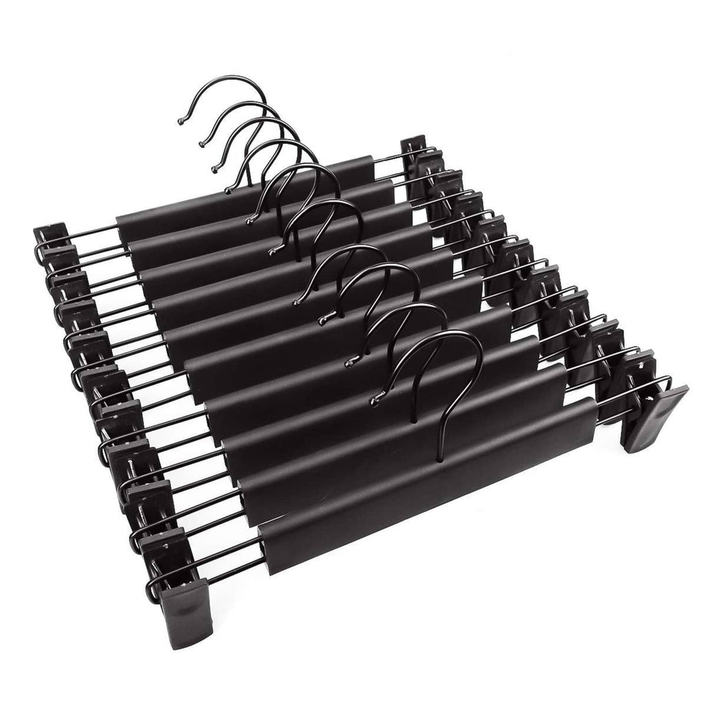 Black pants hanger set with adjustable clips and curved anti-slip grips on a bar