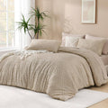 Quilted comforter set in light beige with geometric pattern and matching decorative shams