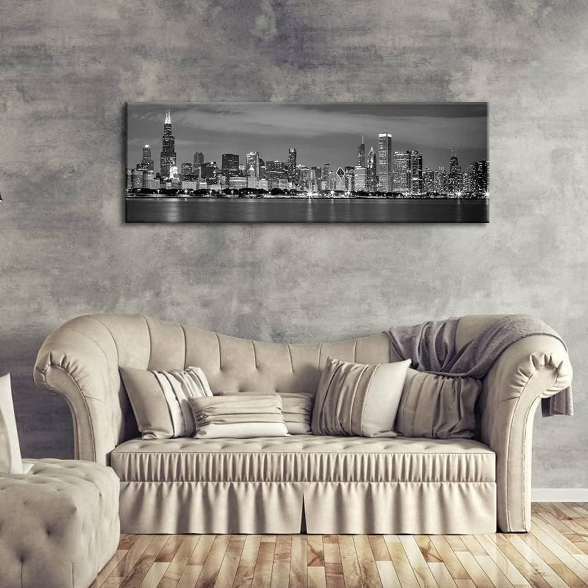 Black and white skyline canvas wall art hanging above a light sofa
